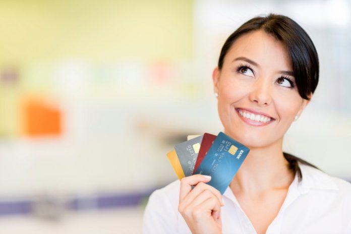 Girl holding credit cards. Why you should get a credit card